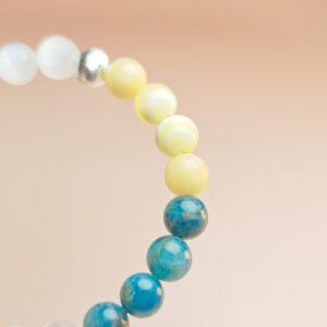 Fortuna Arc crystal bracelet with yellow calcite, blue apatite, and white selenite for wealth and prosperity.