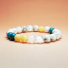 Aqua Aurea crystal bracelet with Yellow Calcite, White Selenite, White Turquoise, and Blue Apatite for stable and flowing wealth.