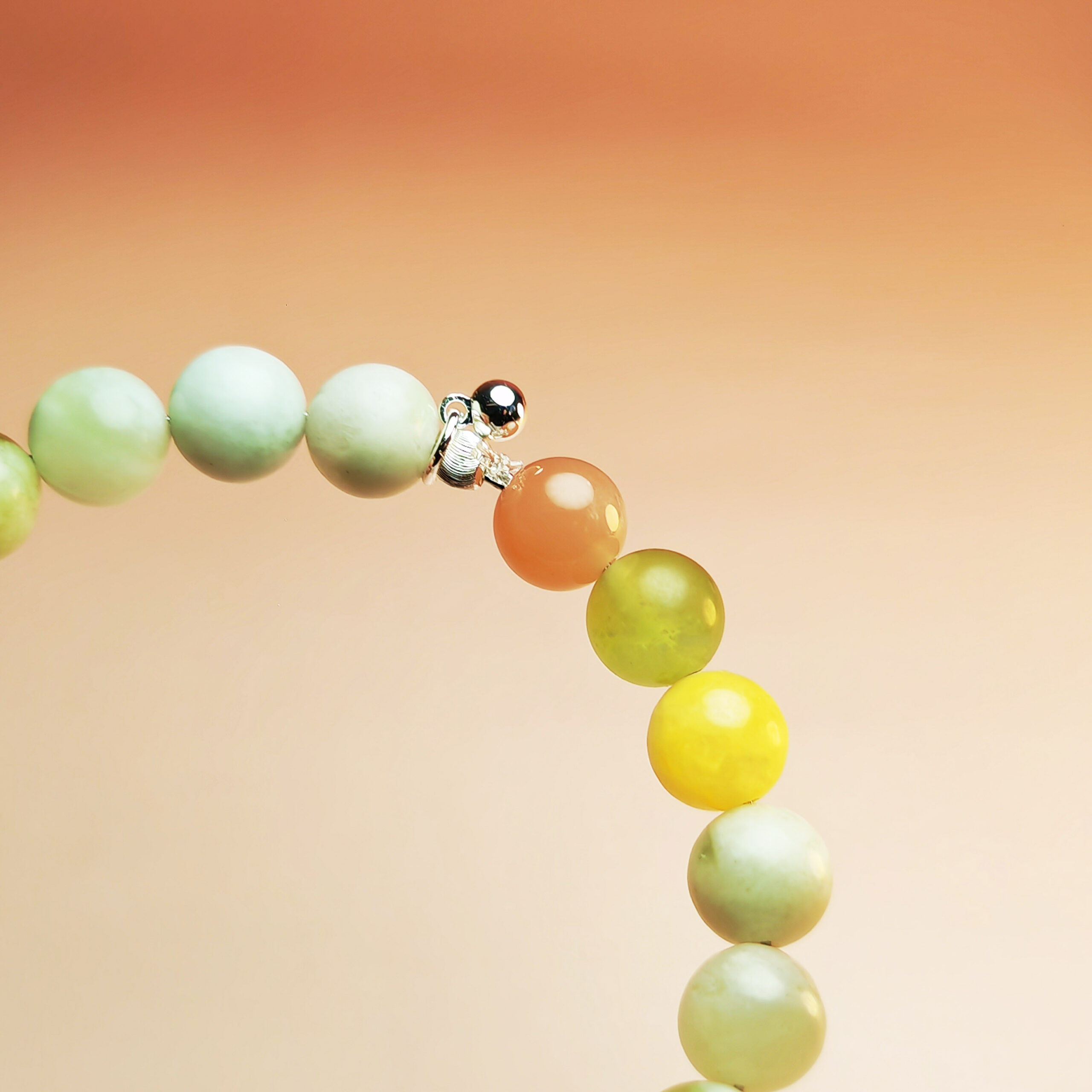 Aurora Threshold crystal bracelet with Green Grape Calcite, Orange Moonstone, and Yellow Calcite for new beginnings and lasting success.