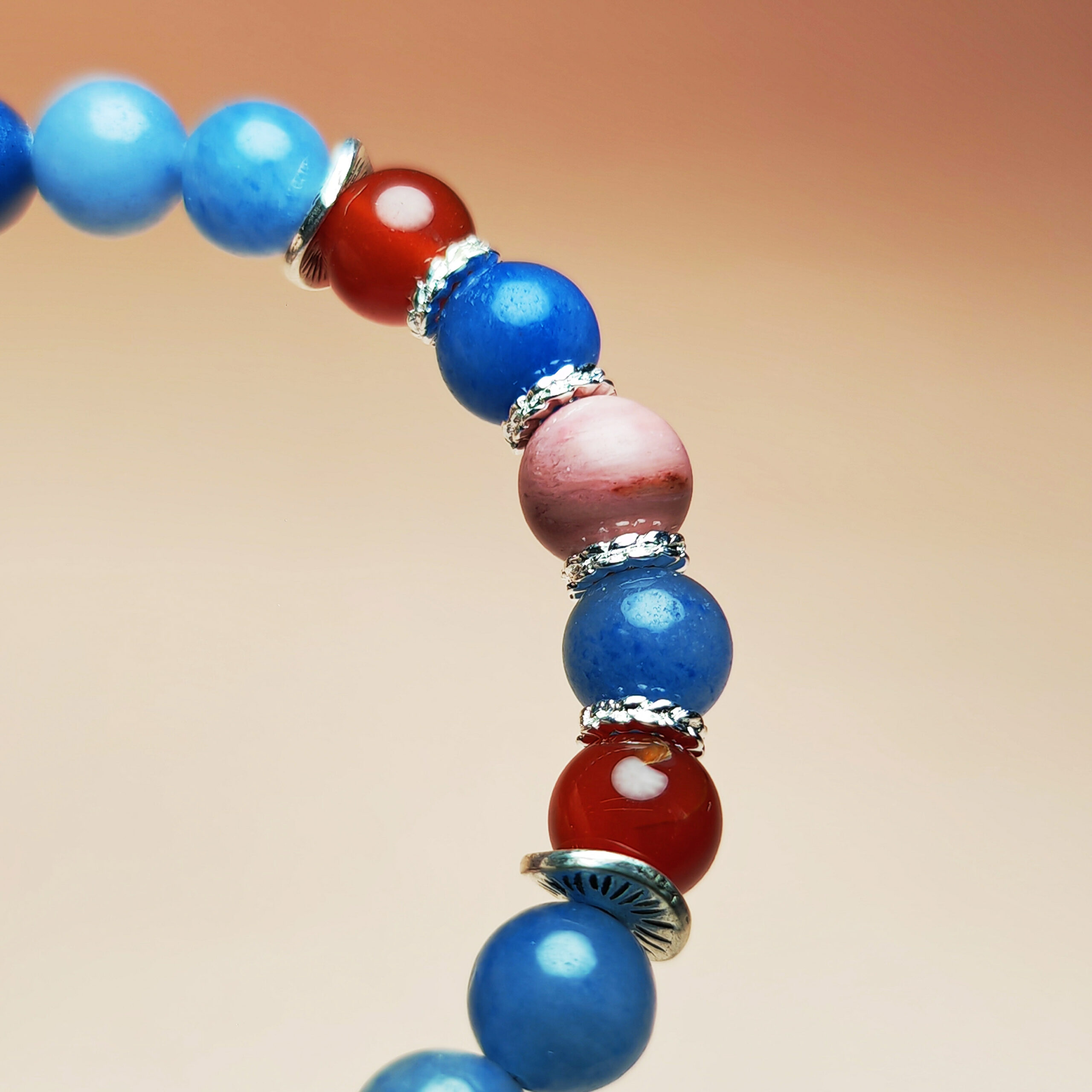 Fortuna Ember crystal bracelet with Red Agate, Red Wood Grain Jasper, and Blue Aventurine for love, fortune, and opportunity.