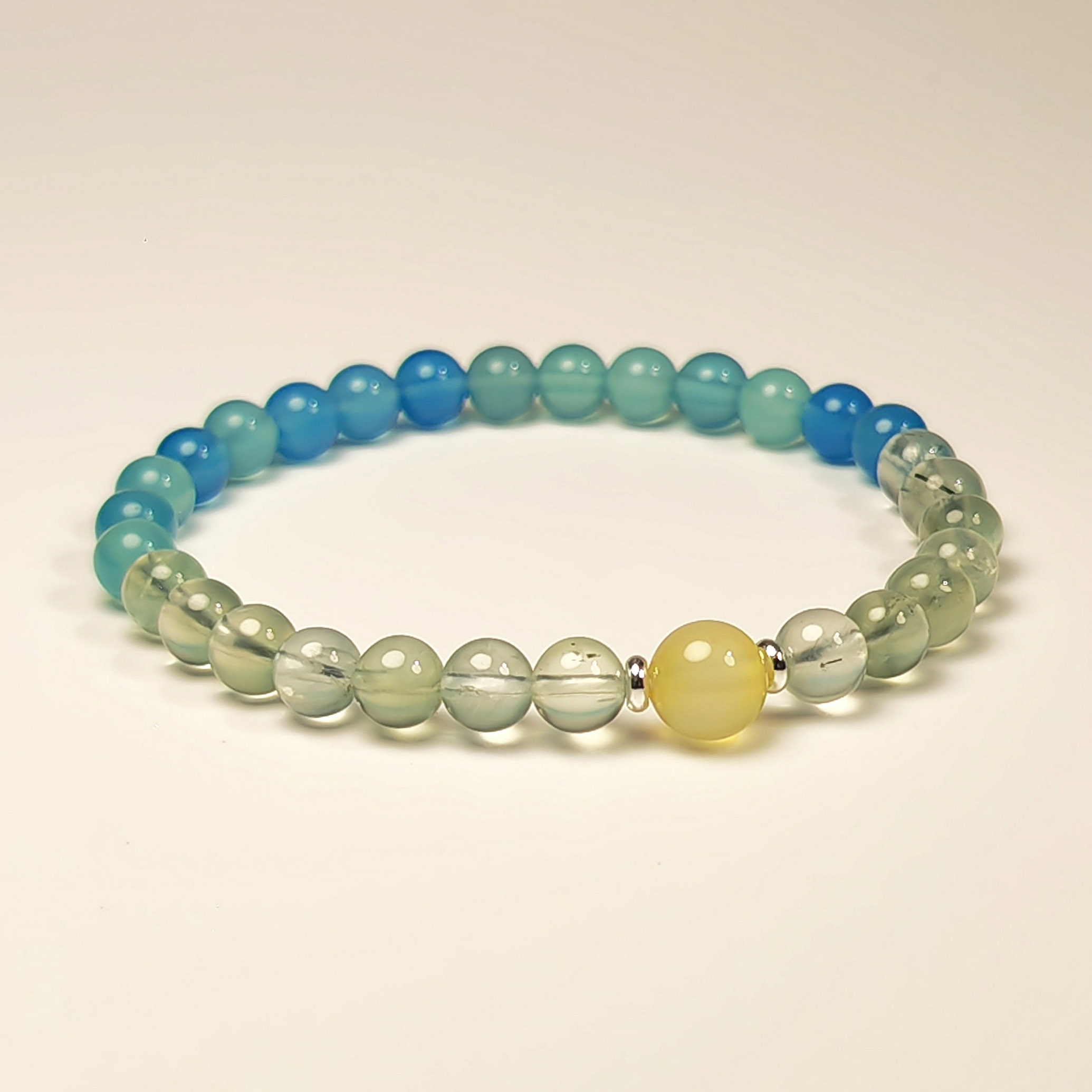 Still Bloom bracelet made with Prehnite, Yellow Agate, and Blue Agate for emotional balance and slow personal growth