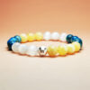 Fortuna Arc crystal bracelet with yellow calcite, blue apatite, and white selenite for wealth and prosperity.