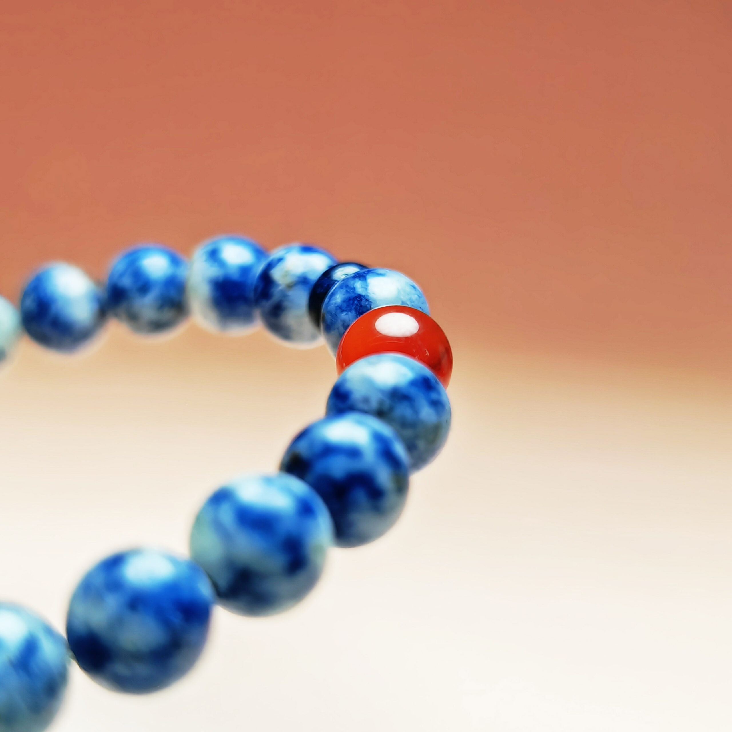 Fortuna Ember crystal bracelet with Red Agate, Red Wood Grain Jasper, and Blue Aventurine for love, fortune, and opportunity.