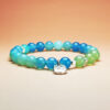 Tidebloom crystal bracelet with blue agate and grape agate for luck, renewal, and health.