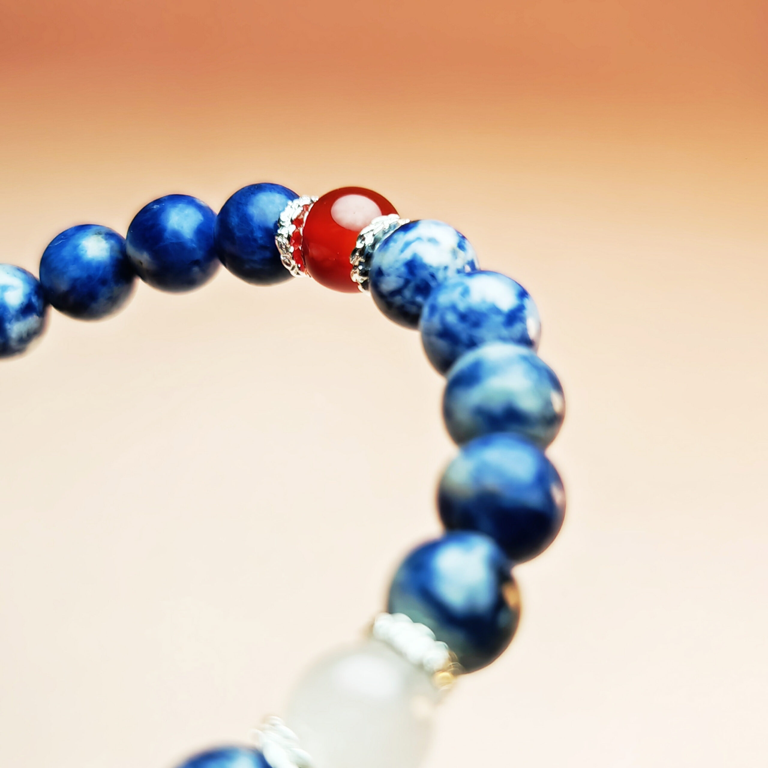 Fortune Tide five element crystal bracelet with dumortierite, grape chalcedony, red agate, white jade, and yellow calcite for protection, wealth, and love.