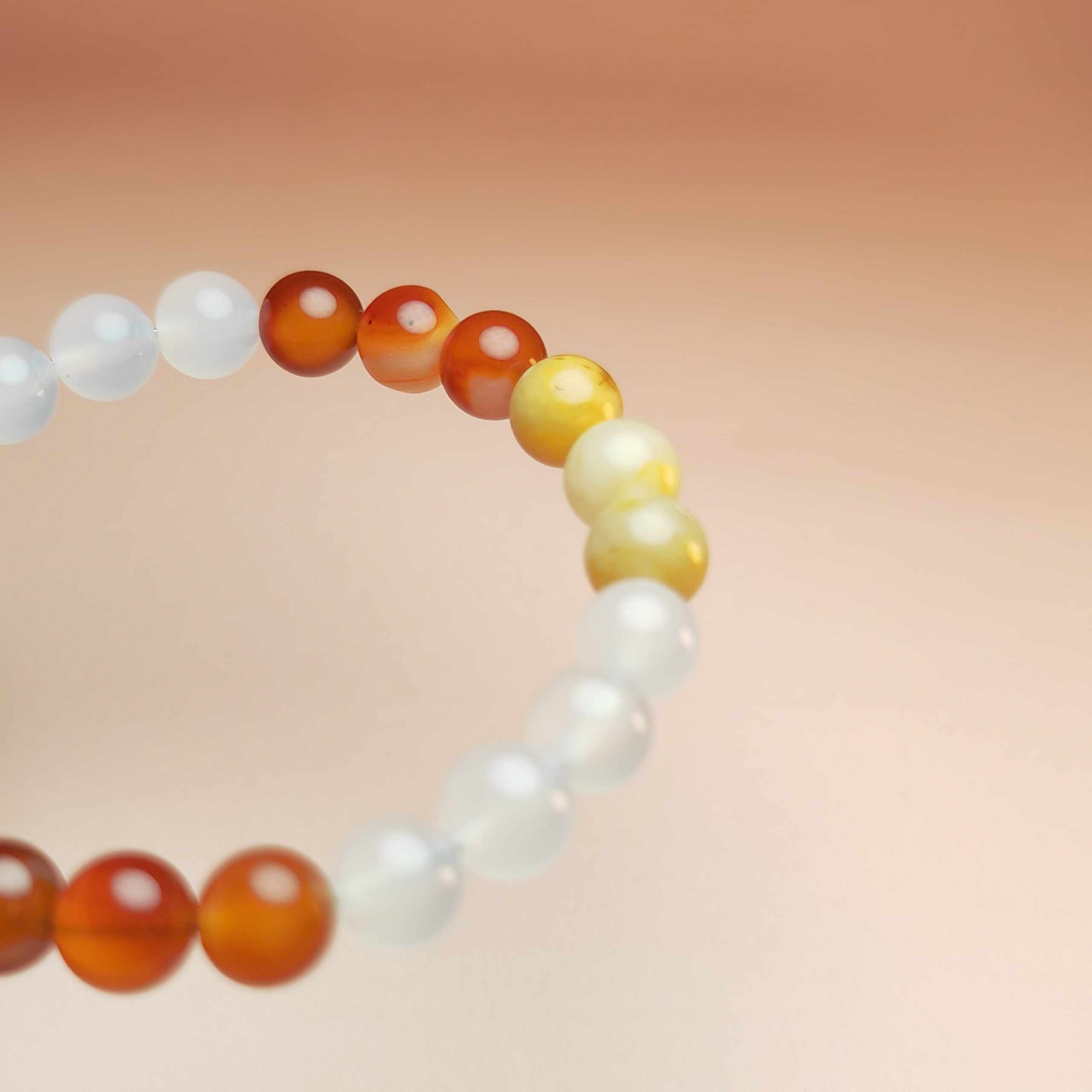 Ember Vault crystal bracelet with red agate, yellow jade, and white agate for wealth, stability, and protection.