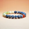 Fortune Rise zodiac crystal bracelet with blue aventurine, grape chalcedony, dumortierite, and red agate for Pisces, Cancer, Leo, and Sagittarius.